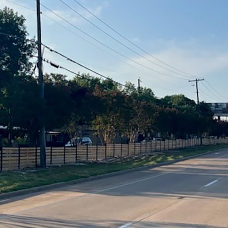 shot of fenced in manufactured home community along roadside